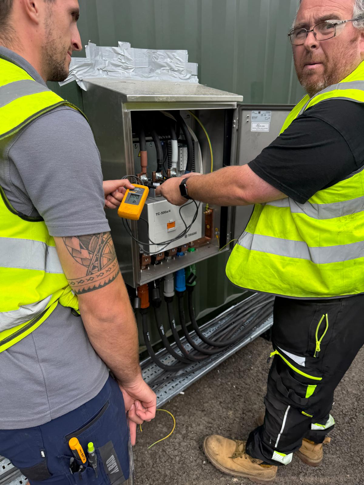 Engineers commissioning the bespoke 500A three-phase contactor and external transfer relay system
